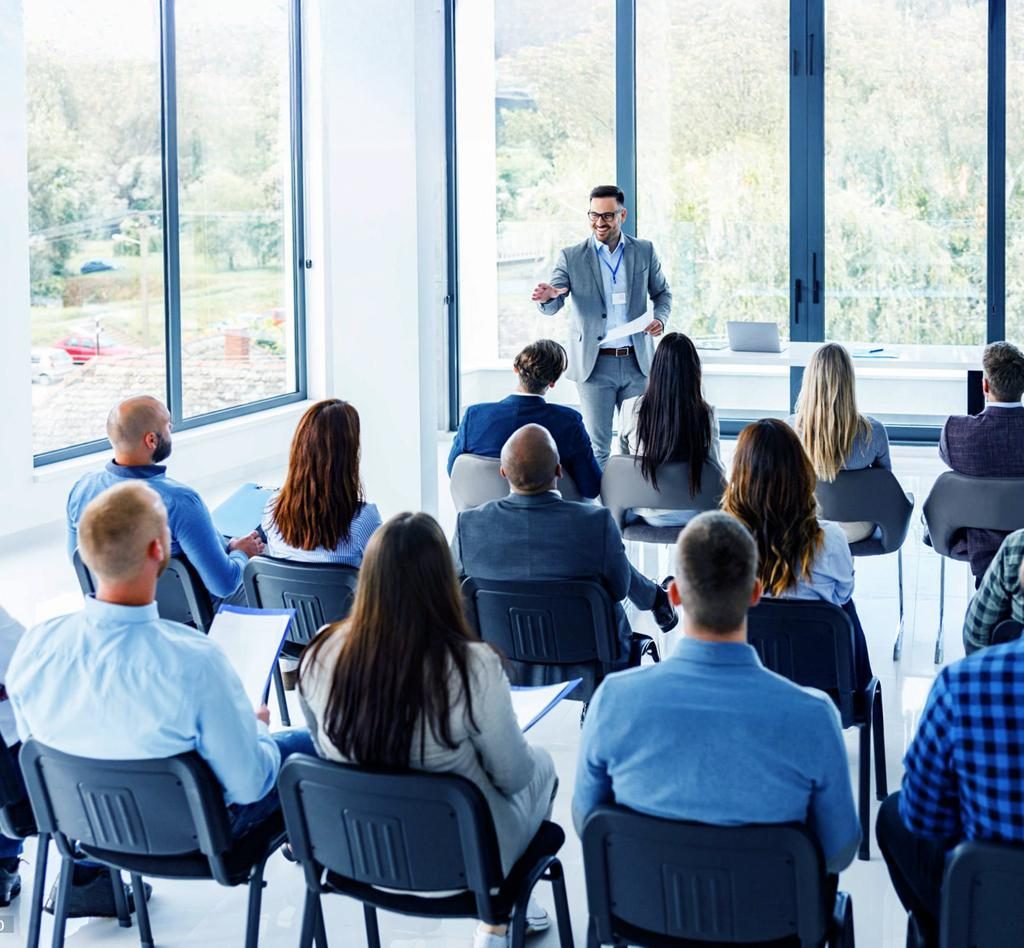 Training and development session with a presenter and seated colleagues